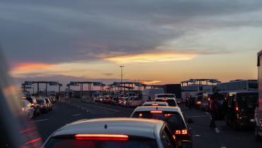 1136x794_What You Need to Know About the Green Card for Driving Abroad.jpg Car at customs checkpoint at dusk