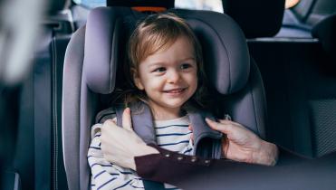 Smiling child in car seat