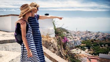 Two women overlooking a beach town