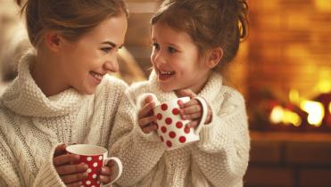 Two girls with Christmas mugs.